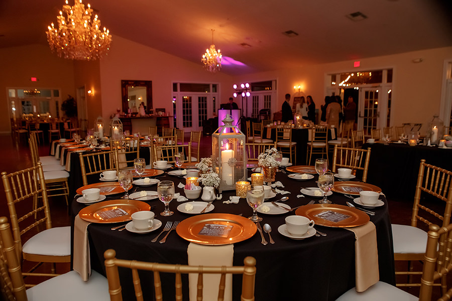 Elegant Rustic Gold Black and Grey Wedding Reception with Vintage Lantern Candleholder, Gold Mercury Votives, and Small White Baby's Breath Bouquets on Black Linen, with Gold Chiavari Chairs | Tampa Bay Wedding Venue The Lange Farm