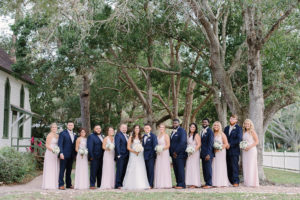 Outdoor Wedding Party Portrait with Ivory Floral Bouquets with Greenery, Groomsmen in Navy Suits, and Blush Pink Mismatched Hayley Paige Bridesmaids Dresses | Tampa Bay Wedding