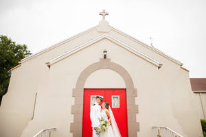Outdoor Bride and Groom Portrait in front of Wedding Ceremony Venue Anona Methodist Church with White Floral and Greenery Bouquet | Tampa Bay Photographer Limelight Photography