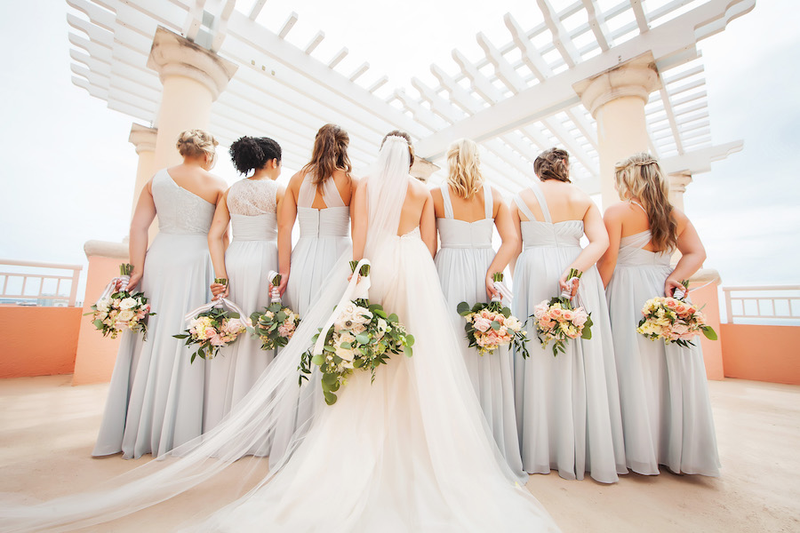 Outdoor Bridal Party Portrait with Light Blue Mismatched Azazie Bridesmaids Dresses and Watters Wedding Dress and White, Pink, Peach, and Yellow Bouquets with Greenery | Hotel Wedding Venue Hyatt Regency Clearwater Resort | Tampa Bay Photographer Limelight Photography
