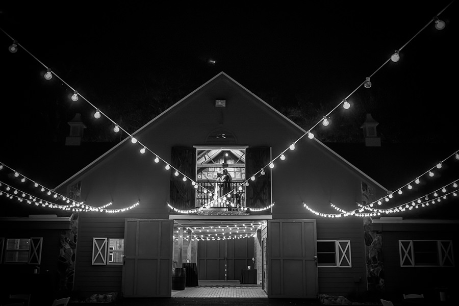 Nighttime Bride and Groom Portrait in Barn with Edison Bulb String Lights | Tampa Bay Wedding Venue The Lange Farm | Photographer Brian C Idocks Photographics
