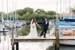 Outdoor Waterfront Wedding Bride and Groom Portrait with Watters Sweetheart Dress, Blush Rose Bouquet with Greenery, and Navy Suit at Tampa Bay Wedding Venue Safety Harbor Resort and Spa