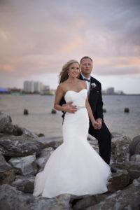 Bridal and Groom Outdoor Sunset Wedding Portrait on Rocks | Clearwater Beach Wedding Photographer Djamel Photography