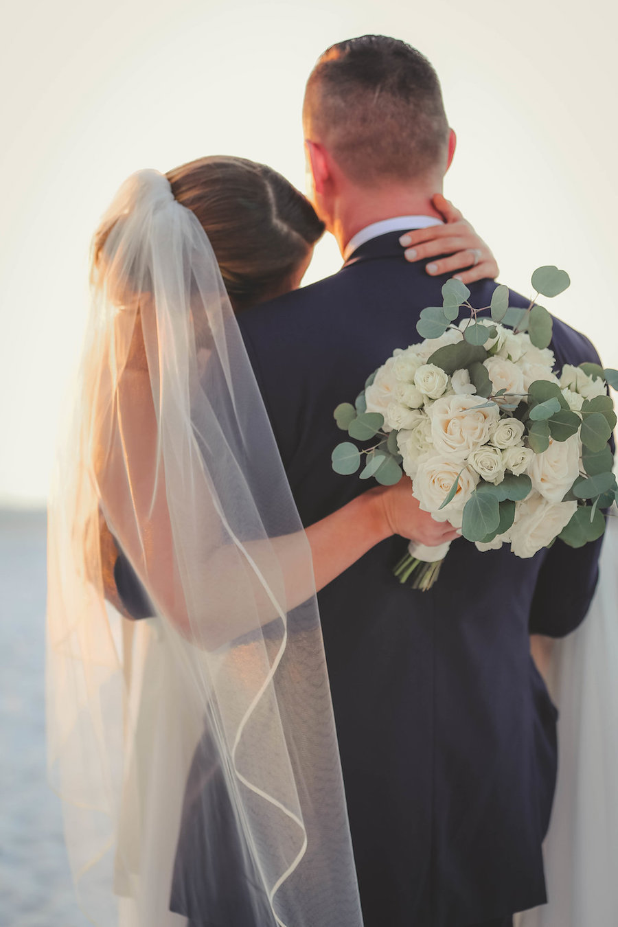 Bride and Groom Florida Beach Wedding Portrait with White Rose and Greenery Bouquet and Navy Suit | Tampa Bay Wedding