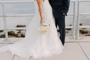 Outdoor Waterfront Wedding Couple Detail Photo Blush Rose Bouquet with Greenery, and Navy Suit at Tampa Bay Wedding Venue Safety Harbor Resort and Spa