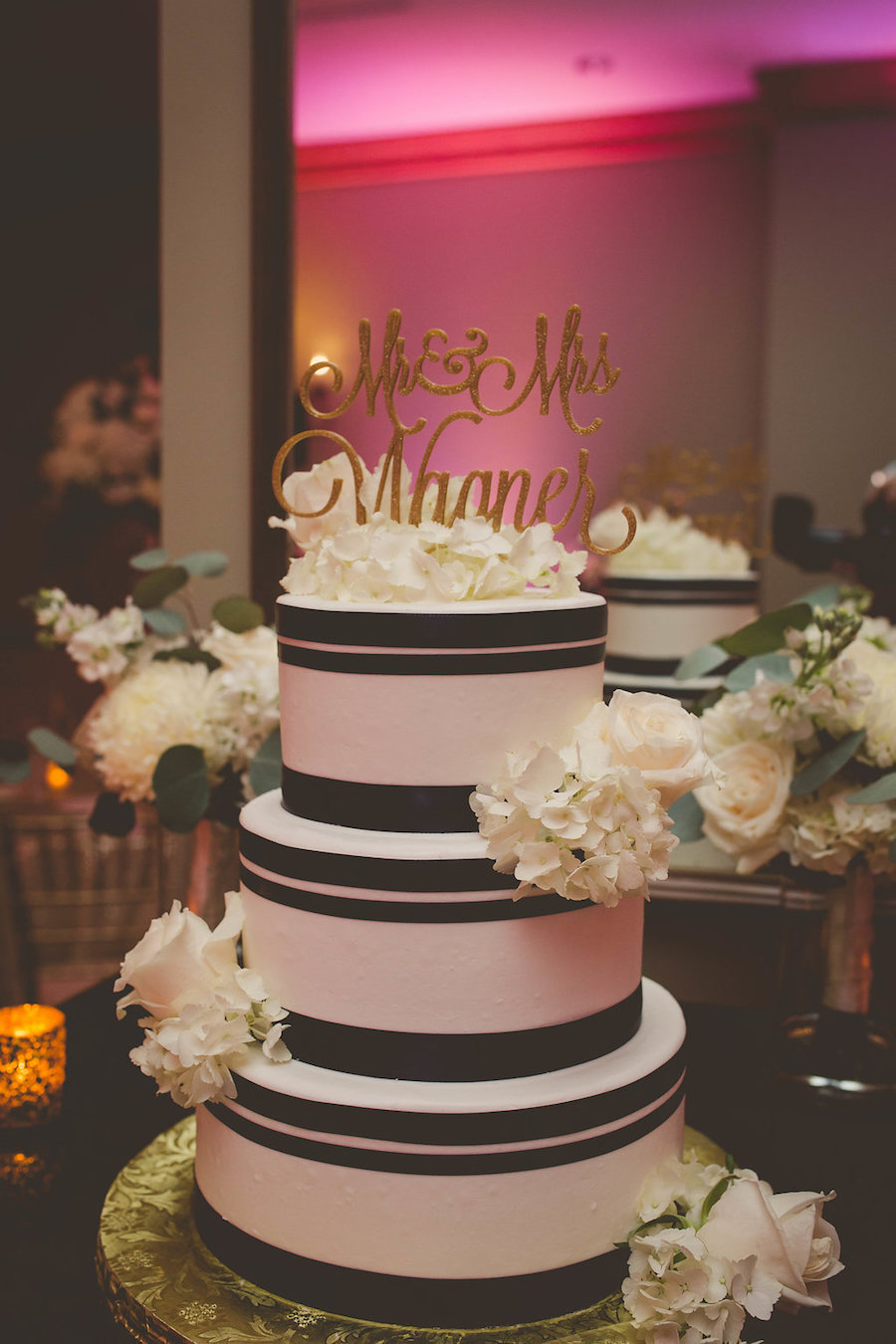 Three Tiered Round Wedding Cake with Vertical Black Stripes and White Hydrangea and Rose Flowers with Gold Mr and Mrs Topper