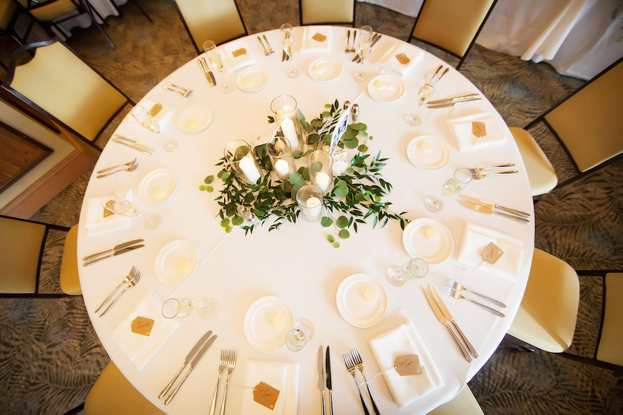 Elegant White Wedding Reception Decor Table Setting with Glass Candle Holders and Natural Greenery Centerpieces and Handwritten Shipping Tag Place Cards | Clearwater Beach Wedding Venue Hyatt Regency