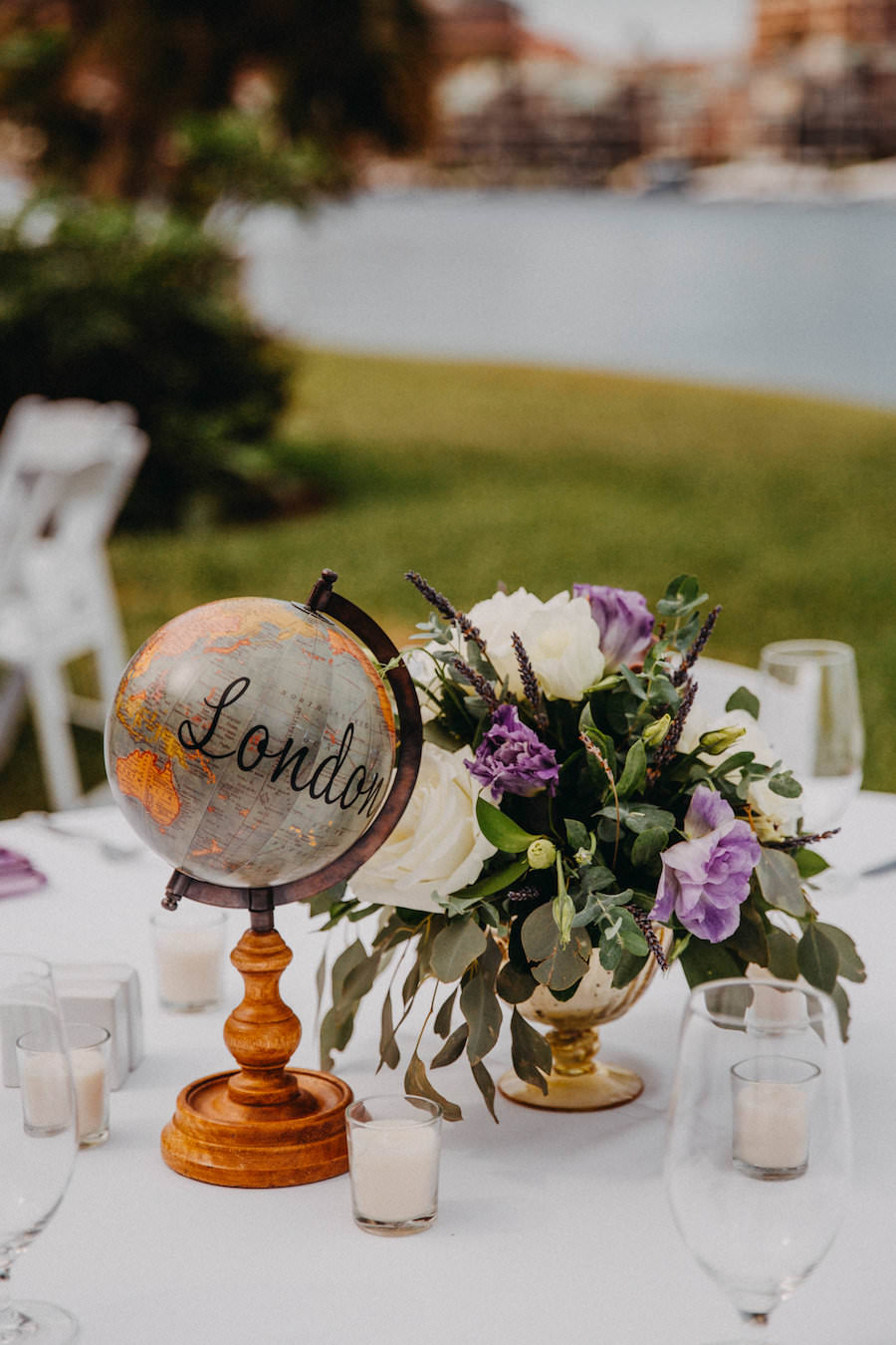 Outdoor Garden Wedding Reception Decor with Purple and White Flowers and Succulent Greenery Centerpieces with Globe Table Number | Travel Themed Wedding Inspiration