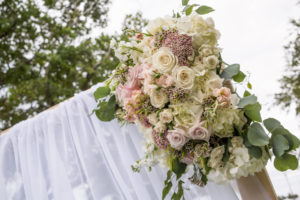 Outdoor Ceremony Decor Sheer Fabric Arch with Dusty Purple, Blush, Ivory and White Rose Bouquet with Natural Greenery