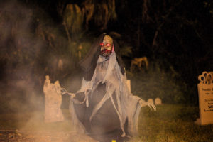 Halloween Themed Outdoor Wedding Decor with Moving Skeleton Ghost and Tombstones | Sarasota Halloween Themed Wedding Smoke Fog by Nature Coast Entertainment Services