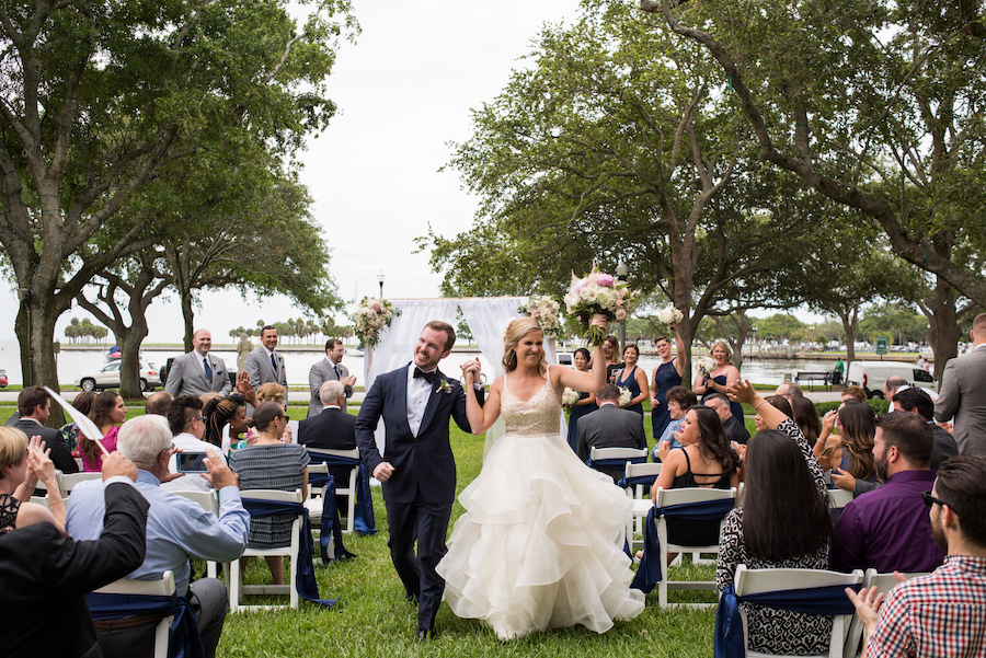 Outdoor Waterfront Wedding Ceremony with White Fabric Curtain Arch, Blush and Ivory Rose Bouquets, and White Folding Chairs | Downtown St Petersburg Wedding Venue North Straub Park | Tampa Bay Wedding Planner Special Moments Event Planning