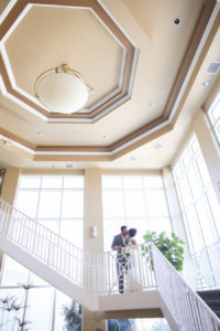 Bride and Groom Portrait with Tall Windows, Staircase and High Ceiling | St. Petersburg Florida Wedding Venue Isla del Sol Yacht & Country Club