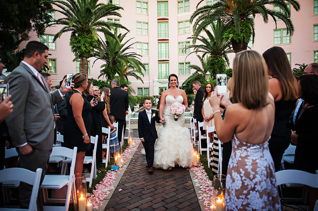 Walking Down the Aisle Outdoor Wedding Ceremony Portrait with Pink Rose Petals and Hurricane Candle Holders | St Pete Wedding Photographer Limelight Photography | Tampa Bay Wedding Venue Vinoy Renaissance