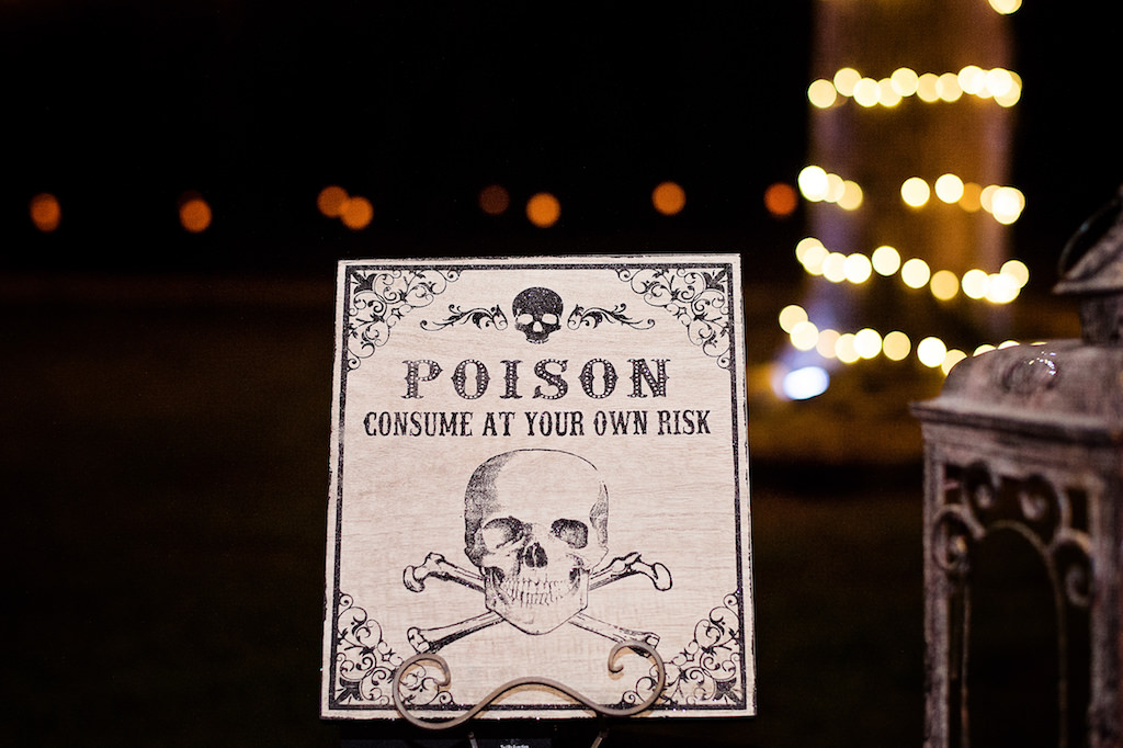 Halloween Inspired Wedding Decor with Poison Skull and Crossbones Sign
