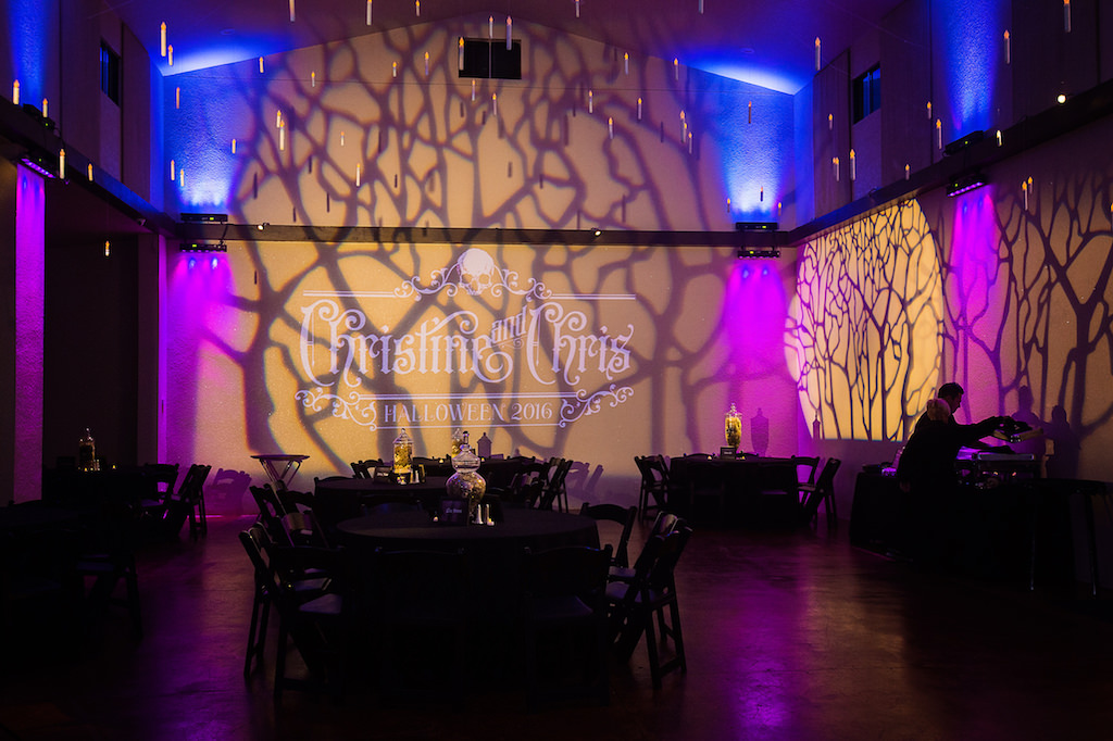 Halloween Inspired Wedding Reception with Black Linen, Antique Apothecary Jar Centerpieces, and Spooky Tree Shadow Projection | Sarasota Wedding DJ and Lighting Nature Coast Entertainment Services