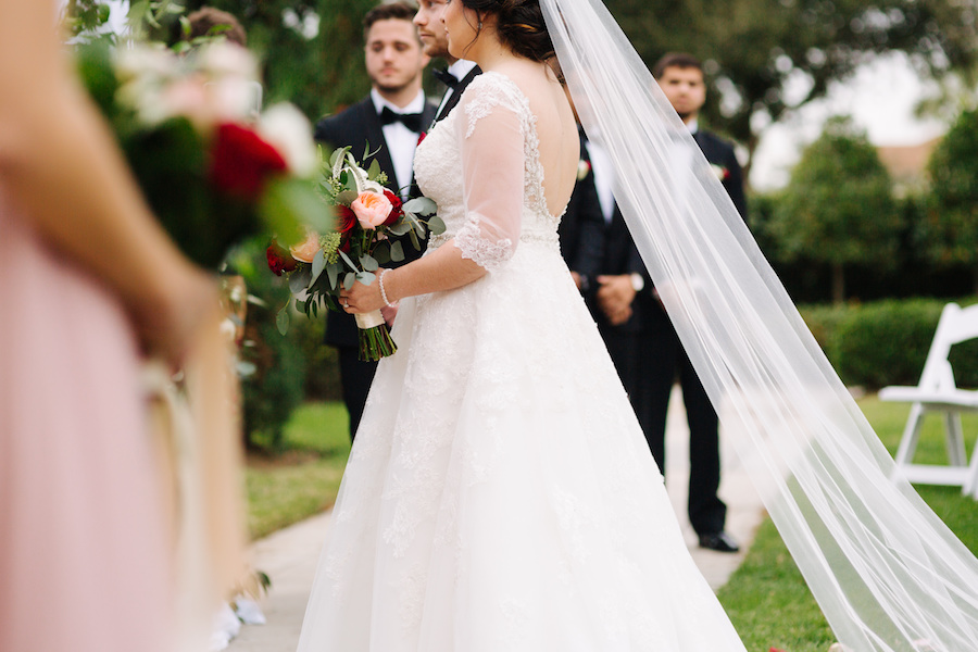Outdoor Garden Wedding Ceremony Bride Portrait with Lace Sleeve Backless Sophia Tolli A Line Wedding Dress with Blush and Red Rose Bouquet with Greenery