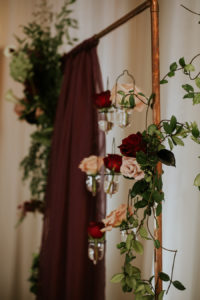 Deep Red Burgundy Wedding Ceremony Decor with Candles and Hanging Floral Rose Draped Altar Backdrop | Tampa Bay Wedding Planner Southern Glam Weddings & Events