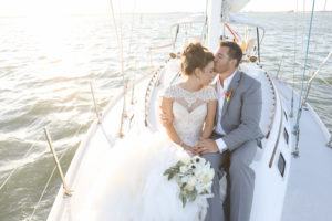 Outdoor Wedding Portrait on Yacht with Beaded Lace Adrianna Papell Wedding Dress and Ivory and Anemone Bouquet, Groom in Grey Suit with Bird of Paradise Boutonnière | St Pete Wedding Venue Isla del Sol Yacht & Country Club