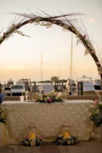 Waterfront Wedding Reception Decor with Sweetheart Table Natural Branch Arch with Baby's Breath and White and Pink Roses and Greenery with Lanterns | Tampa Bay Wedding Venue Westshore Yacht Club