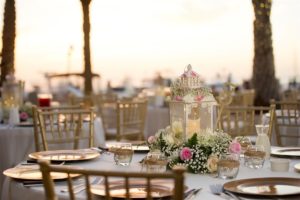 Waterfront Outdoor Wedding Reception Table Decor with Gold Chargers and Chiavari Chairs, Beachy Glass Votives, Baby's Breath and White and Pink Roses and Fern Centerpiece and Lanterns | Tampa Bay Wedding Venue Westshore Yacht Club