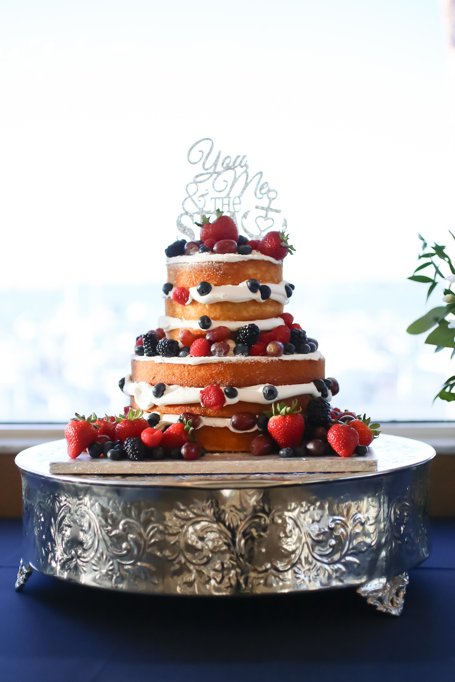 Two Tiered Layered Naked Wedding Cake with Berries on Silver Serving Platter with Nautical Glitter Cake Topper