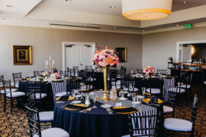 Black, Gold, and White Wedding Reception Decor with Striped Runners, Black Linens, Tall Gold Vase Centerpiece with Peach and Purple Orchid Tropical Flowers and Black Chiavari Chairs | Downtown Tampa Wedding Venue The Centre Club