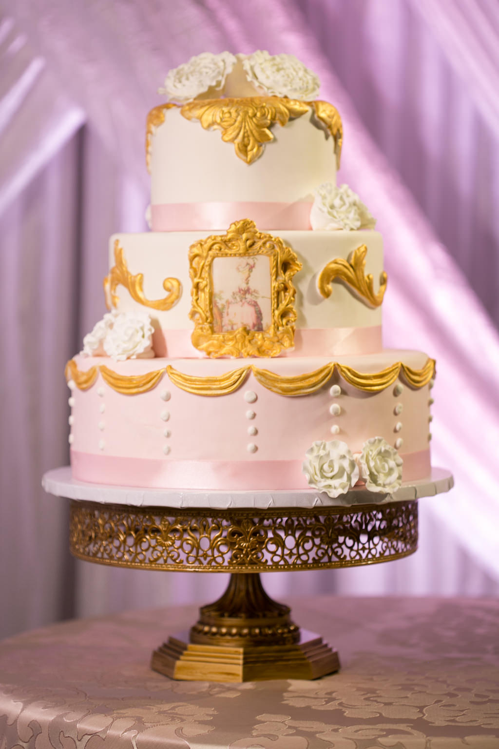 Three Tiered Round Wedding Cake with White Floral and Gold Gilded Picture Frame and Pink Ribbon Decor on Antique Gold Cake Stand | Tampa Bay Wedding Bakery A Piece of Cake