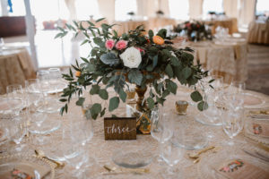Rustic Wedding Reception Table Decor with Handpainted Wooden Table Number and White, Pink, and Orange Rose with Natural Greenery Centerpiece in Tall Vase | Sarasota Wedding Planner NK Productions
