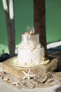 Beach Inspired Two Tier Round Wedding Cake with Coral Starfish and Seashells and Fishing Net Decor