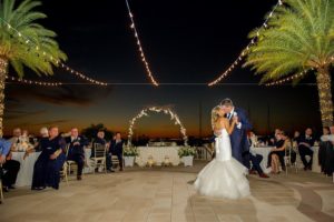 Outdoor Nighttime First Dance Portrait at Waterfront Wedding Reception with Edison Bulb String Lights and Floral Arch | Tampa Bay Wedding Venue Westshore Yacht Club | Photographer Andi Diamond Photography