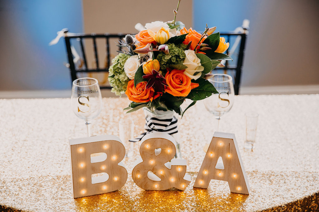 Black White and Gold Wedding Reception Bride and Groom Table with Block Letter Initial Signs and Tropical Orange and Greenery Bouquet