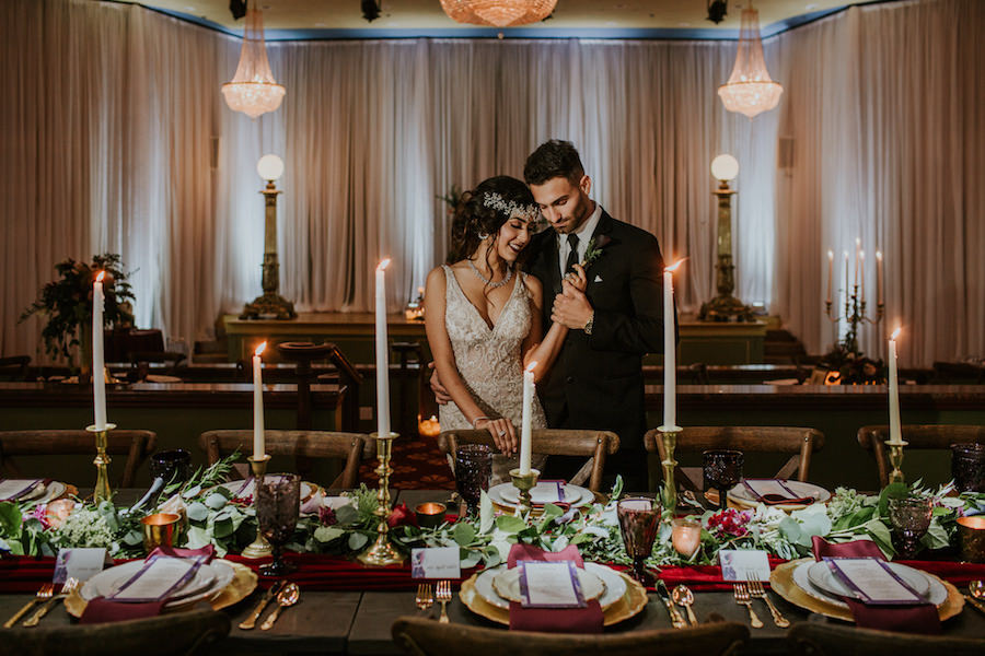 Romantic Vintage Glam Wedding Reception Centerpieces and Decor with Taper Candles Red Velvet Runner and Garland Florals | Planner Southern Glam Weddings & Events | Unique Tampa Bay Wedding Venue Safety Harbor Resort and Spa Theatre | Dish Rentals Ever After Vintage Weddings | Photographer Brandi Image Photography