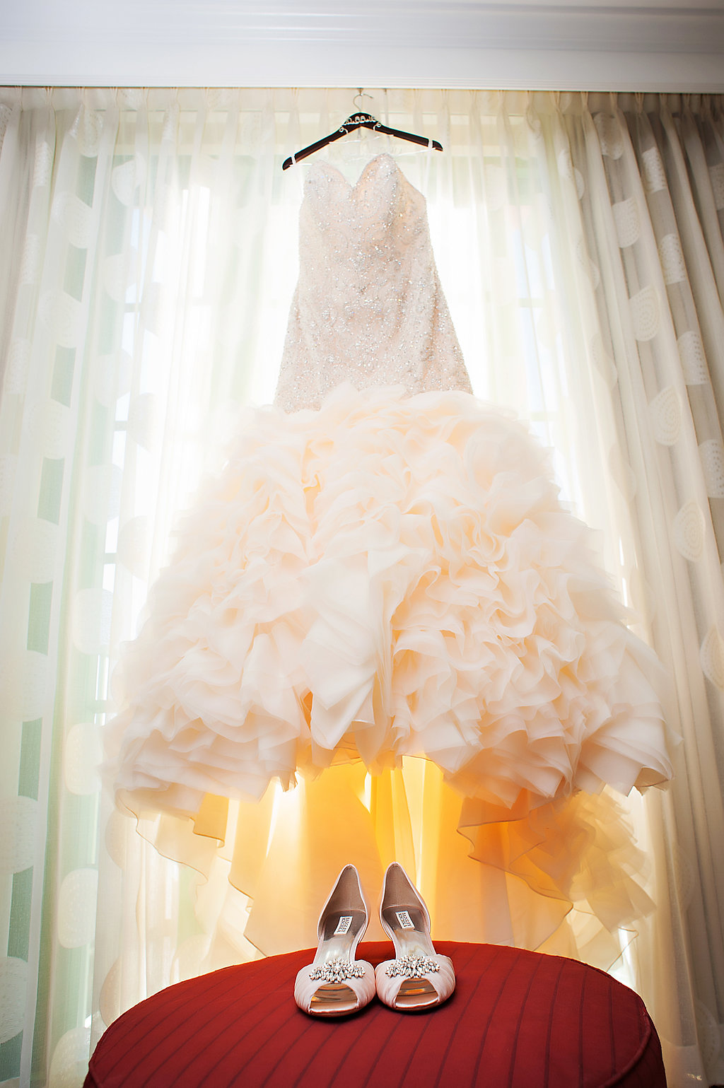 Blush Pink Mermaid Wedding Dress on hanger with Blush Pink Jeweled Peep Toe Wedding Shoes