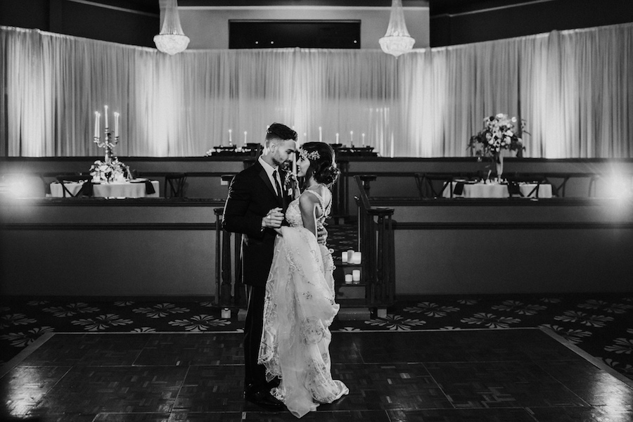 Vintage Glam 1920s Groom and Bride First Dance Portrait with Deep V-Neck Plunging Open Back Wedding Dress with Beading | Tampa Bay Wedding Photographer Brandi Image Photography | Romantic Vintage Glam Wedding | Unique Tampa Bay Wedding Venue Safety Harbor Resort and Spa Theatre