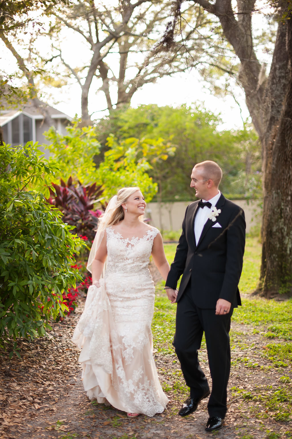 Outdoor Garden Bride and Groom Wedding Portrait wearing Allure Bridal Cream Lace Wedding Dress