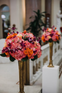 Tall Tropical Wedding Ceremony Flowers with Pink, Orange, and Purple Orchids in Gold Vases