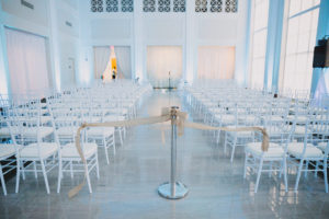 Wedding Ceremony Decor with White Chiavari Chairs and Gold Ribbon | Tampa Bay Wedding Venue The Vault