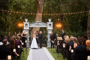 Outdoor Wedding Ceremony Portrait with Black and White Strapless Wedding Dress and Halloween Decor Tombstone Ceremony Arch and Black and White Fabric Aisle | Bradenton Wedding Planner Special Moments Event Planning