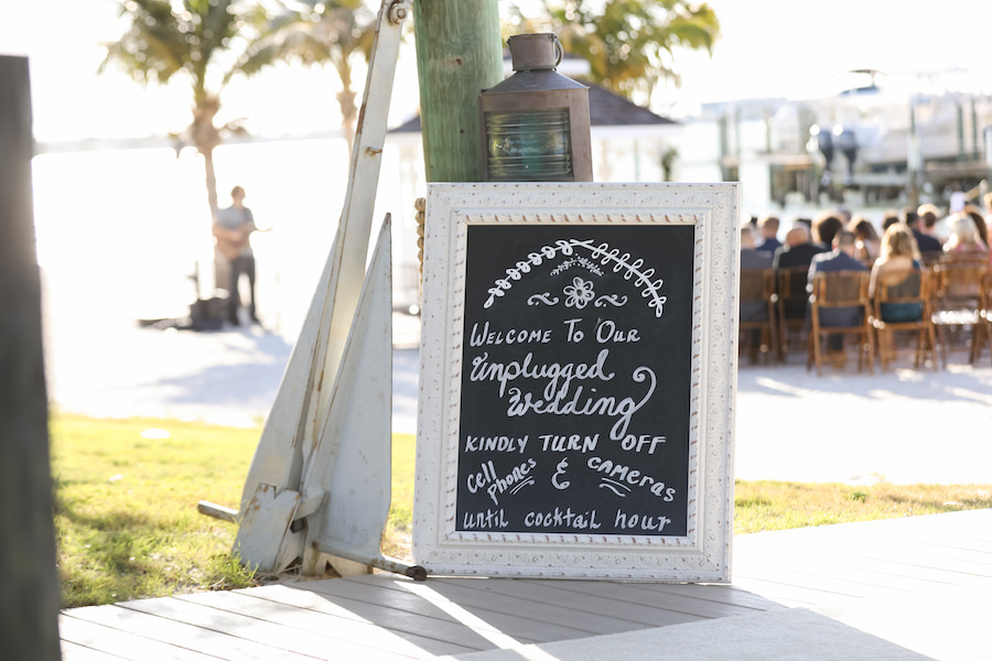 Chalkboard Welcome Sign with Ship Lantern and Anchor at Outdoor Waterfront Wedding Ceremony | Tampa Bay Wedding Venue Isla Del Sol Yacht & Country Club