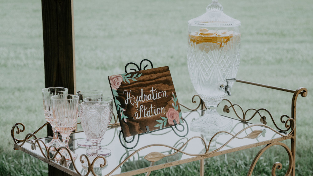 Elegant Rustic Barn Wedding Reception Decor Hydration Station with Handpainted Wooden Sign with Flowers and Vintage Drink Cart | Rustic Vintage Sarasota Wedding Rentals Kelly Kennedy Weddings and Events