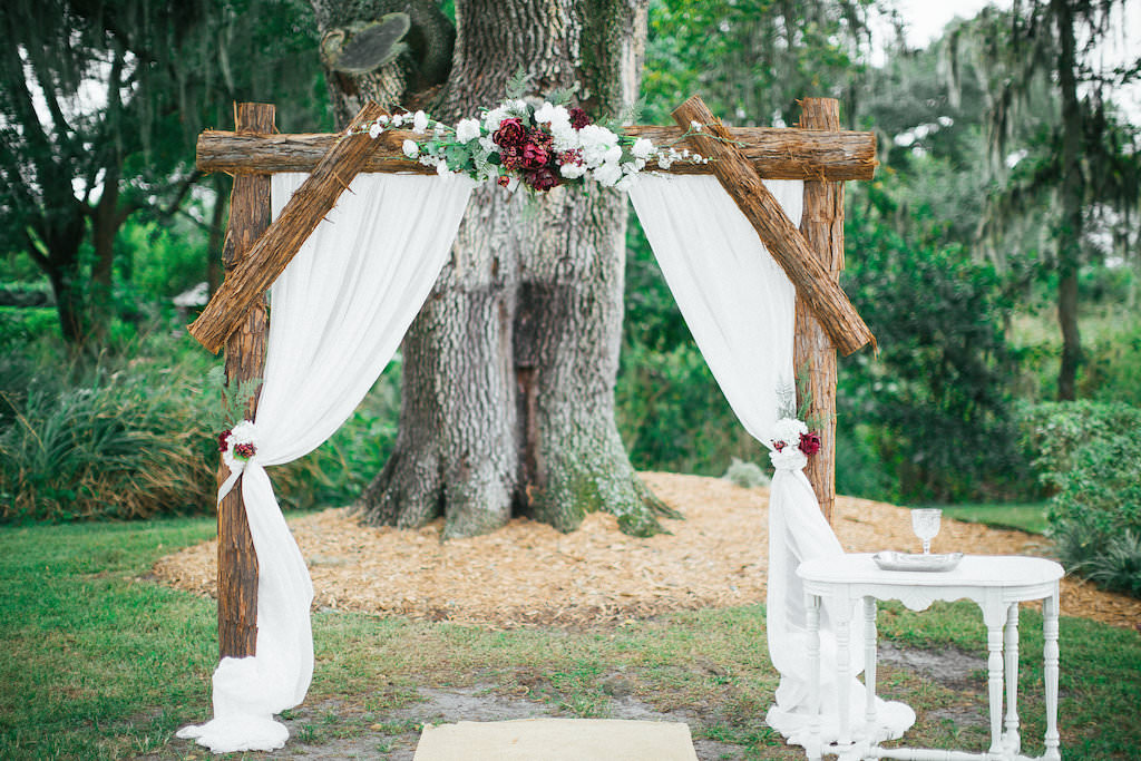 Wedding Ceremony Arch Decor with Drapery and Red Berries, Marsala and Cream Flowers, Ferns and Greenery