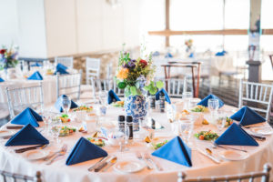 Blue Vintage Asian Inspired Wedding Decor with Colorful Orange and Purple Flower Centerpieces in Antique Vase | Venue St. Petersburg Country Club