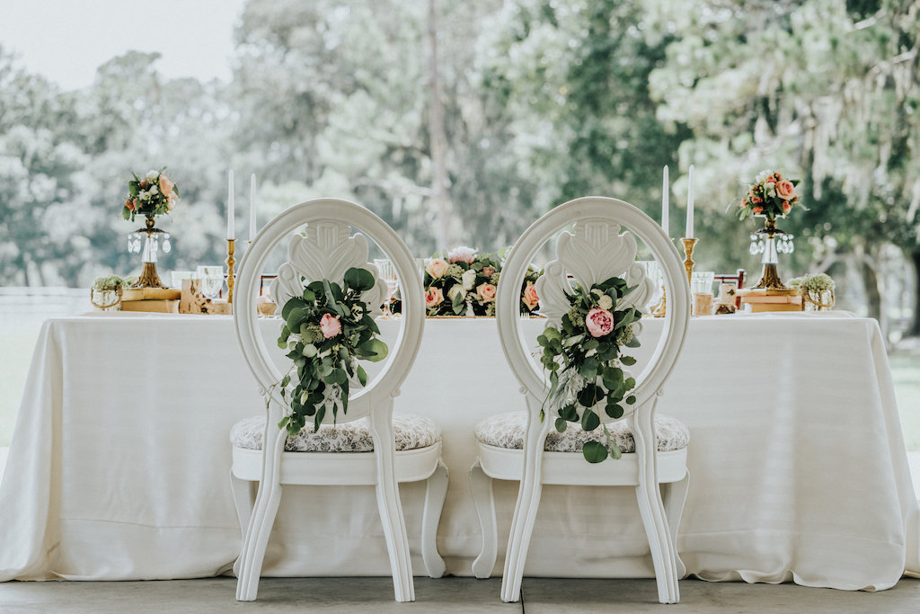 Outdoor Rustic Farm Wedding Reception Bride and Groom Table Decor with Blush Roses and Greenery, Antique White Chairs, Low Peach Rose Centerpiece and Small Centerpieces in VIntage Vases, with Mercury Votives, Gold Candlestick holders, and Succulents | Outdoor Rustic Farm Wedding Reception Bride and Groom Table Decor with Blush Roses and Greenery, Antique White Chairs, Low Peach Rose Centerpiece and Small Centerpieces in VIntage Vases, with Mercury Votives, Gold Candlestick holders, and Succulents | Sarasota Wedding Rentals Kelly Kennedy Weddings and Events