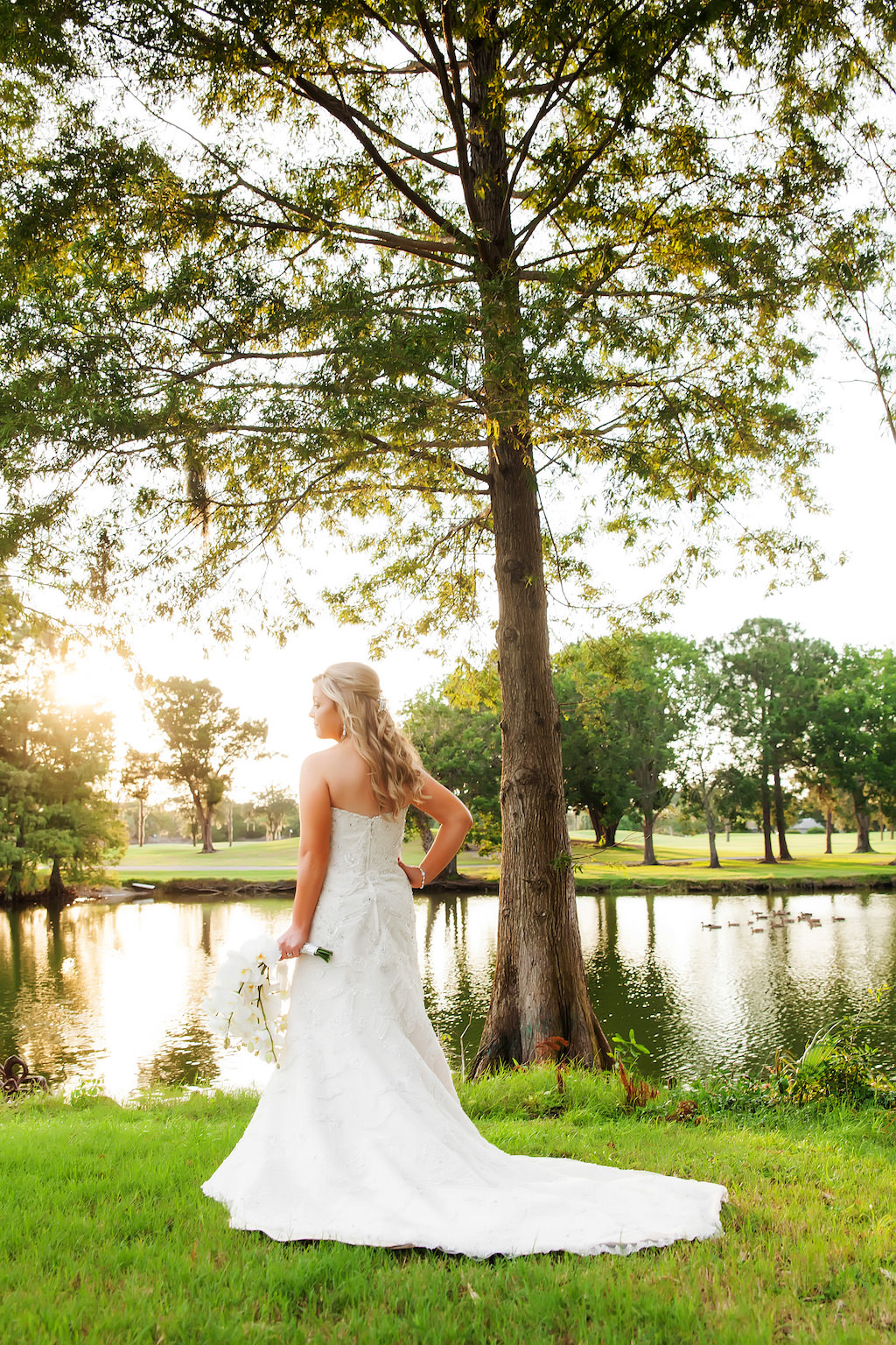 Outdoor Garden Bridal Portrait in Strapless A Line Wedding Dress with White Orchid Bouquet | Clearwater Wedding Photographer Limelight Photography