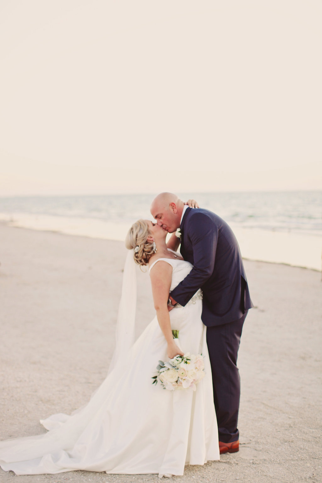 Outdoor Beach Bride and Groom Wedding Portrait, Bride with White and Greenery Bouquet, Groom in Navy Blue Suit | Tampa Bay Wedding