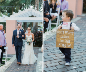 Wedding Ceremony Aisle Portraits of Bride and Groom with White Bouquet with Greenery and BLush Pink Tie and Navy Suit, and Ring Bearer with Pink Bowtie and Converse Sneakers with Funny I'm Still Single Wooden Painted Sign | St Pete Wedding Planner Parties A La Carte