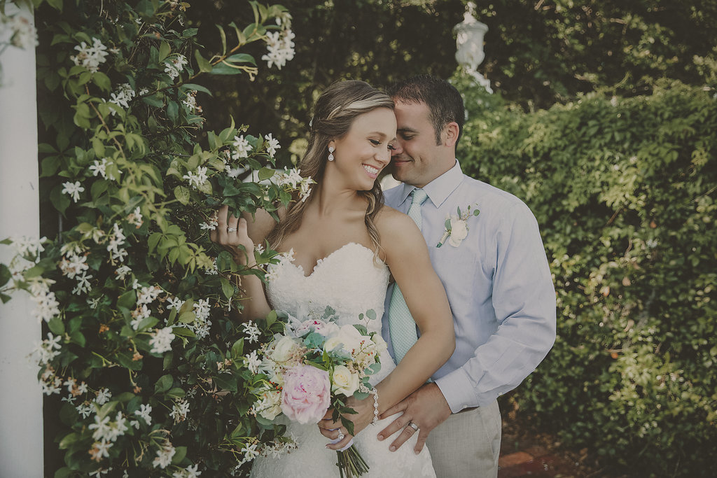 Bride and Groom Outdoor Garden Wedding Portrait, with White Rose and Pink Peony Bouquet, Groom in Blue Shirt, Sea Foam Green Tie and White Floral Boutonniere with Greenery | Tampa Bay Old Florida Inspired Wedding