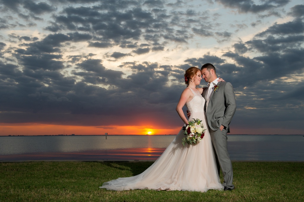 Waterfront Sunset Wedding Portrait with White, Pink, and Red Rose Bridal Bouquet with Greenery and Red Rose Boutonniere, Blush Wedding Dress | Tampa Bay Florida Wedding Photographer Andi Diamond Photography | Waterfront Sunset Wedding Portrait with White, Pink, and Red Rose Bridal Bouquet with Greenery and Red Rose Boutonniere | Tampa Bay Florida Wedding Photographer Andi Diamond Photography | Hair and Makeup Michele Renee The Studio