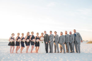 Wedding Party Outdoor Beach Portrait with Groomsmen in Gray Suits with Blue TIes, Bridesmaids in Short Mismatched Navy Blue Bridesmaids Dresses with Pink and White Rose Bouquet | Tampa Bay Wedding Photographer Caroline and Evan Photography