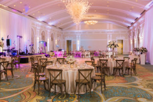 Elegant Blush Pink Satin Linen and Gold Accents Hotel Ballroom Wedding Reception with Tall and Medium Height Full Centerpieces with Greenery | Natural Wood Chiavari Chairs from Tampa Bay Wedding Rentals a Chair Affair | St Pete Wedding Venue The Vinoy Renaissance | Tampa Bay Wedding Planner Parties A La Carte